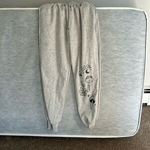 SHEIN pants with cute boho design on the bottom of the left leg